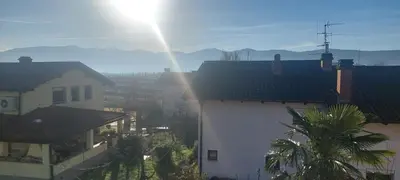 a group of buildings with the sun shining behind them at apartma Kiana in Šempeter pri Gorici