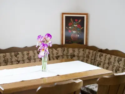 a vase of purple flowers sitting on a table at Apartment Appartement in Zasip mit Möblierter Terrasse by Interhome in Bled