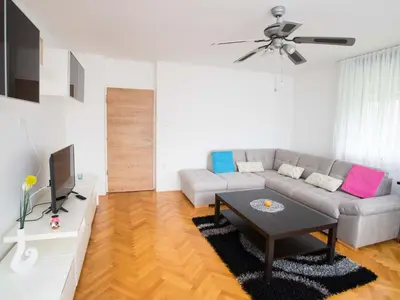 a living room with a couch and a table at Apartment Tolle Ferienwohnung in Zasip mit Parkplatz by Interhome in Bled