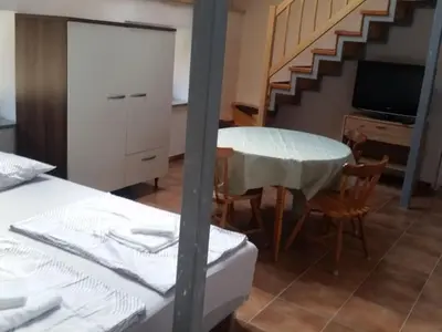 a room with a table and a kitchen and a staircase at Apartment für 4 Personen ca- 60 m² in Gozd- Krain - Innerkrain by Interhome in Gozd