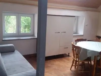 a living room with a table and a white cabinet at Apartment für 4 Personen ca- 60 m² in Gozd- Krain - Innerkrain by Interhome in Gozd