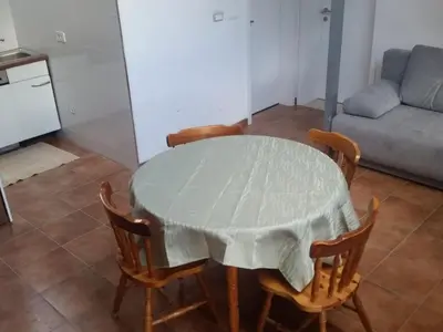 a dining room table with a white table cloth on it at Apartment für 4 Personen ca- 60 m² in Gozd- Krain - Innerkrain by Interhome in Gozd