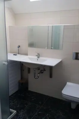 a bathroom with a white sink and a toilet at Apartment für 4 Personen ca- 60 m² in Gozd- Krain - Innerkrain by Interhome in Gozd