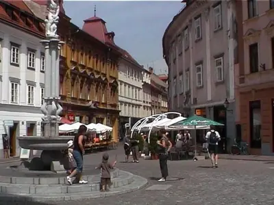 a group of people standing around a fountain in a city at Apartment Wohnung Rozika by Interhome in Slovenj Gradec