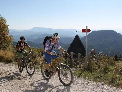 two people riding bikes on a mountain road at Apartment Wohnung Rozika by Interhome in Slovenj Gradec