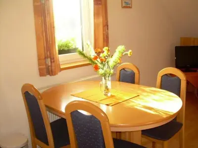 a dining room table with a vase of flowers on it at Apartment Wohnung Rozika by Interhome in Slovenj Gradec