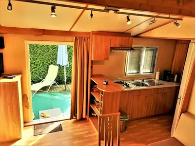 a kitchen with a sink and a stove top oven at Apartment Stacaravan Rozika Slowenien by Interhome in Slovenj Gradec