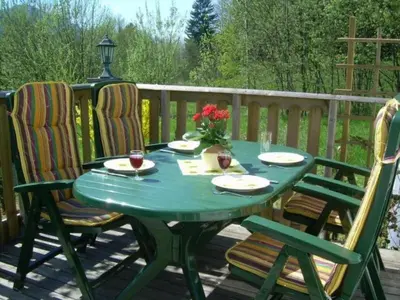 a green table and chairs on a deck at Apartment Stacaravan Rozika Slowenien by Interhome in Slovenj Gradec