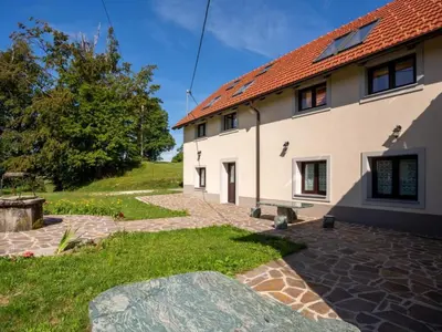a large white building with a brick courtyard at Apartment Studio für 4 Personen ca- 106 m² in Gozd- Krain - Innerkrain by Interhome in Gozd