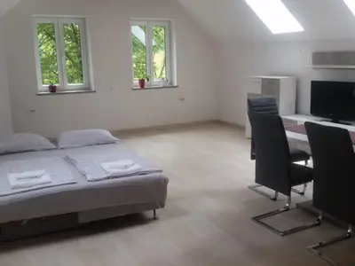 a bedroom with a bed and a desk with chairs at Apartment Studio für 4 Personen ca- 106 m² in Gozd- Krain - Innerkrain by Interhome in Gozd