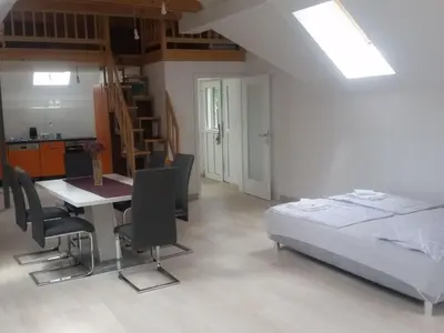 a bedroom with a bed and a table and chairs at Apartment Studio für 4 Personen ca- 106 m² in Gozd- Krain - Innerkrain by Interhome in Gozd
