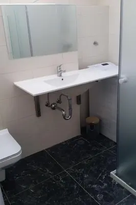 a bathroom with a white sink and a toilet at Apartment Studio für 4 Personen ca- 106 m² in Gozd- Krain - Innerkrain by Interhome in Gozd