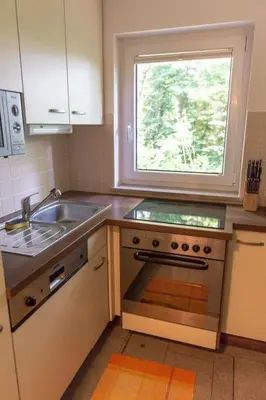 a kitchen with a sink and a stove and a window at Apartment Kleines Haus am Rande des Waldes by Interhome in Kranj