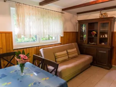 a living room with a couch and a table at Apartment Kleines Haus am Rande des Waldes by Interhome in Kranj