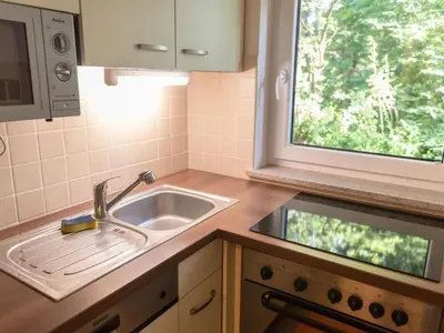 a small kitchen with a sink and a window at Apartment Kleines Haus am Rande des Waldes by Interhome in Kranj