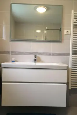 a bathroom with a white sink and a mirror at Apartment Wohnung Lapanja 2 mit Gemeinschaftsgarten by Interhome in Slappe dʼIdria