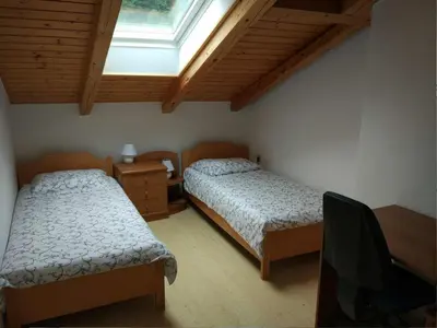 a bedroom with two beds and a skylight at Apartment mit eigener Sonnenterrasse by Interhome in Slappe dʼIdria