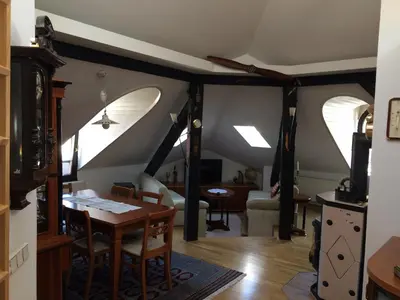 a living room with a table and a dining room at Apartment Loft in Ljubljana