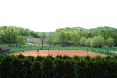 a baseball field with people playing on it at Guest House Gostišče Jutriša in Rogatec