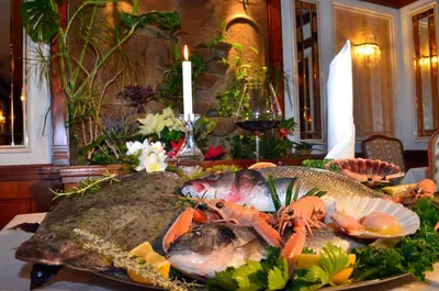 a plate of food with fish and vegetables on a table at Guest House Gostišče Jutriša in Rogatec