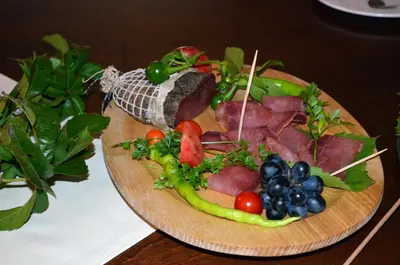 a plate of food with meat and vegetables on a table at Guest House Gostišče Jutriša in Rogatec