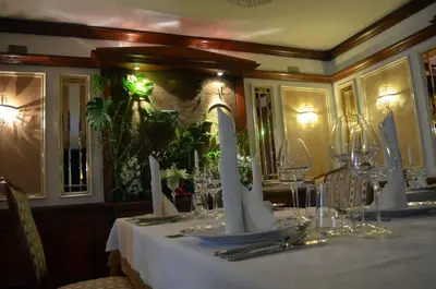 a table with a white table cloth and glasses on it at Guest House Gostišče Jutriša in Rogatec