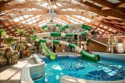 a large swimming pool with a water slide at Casa Termalis in Terme Čatež in Brežice