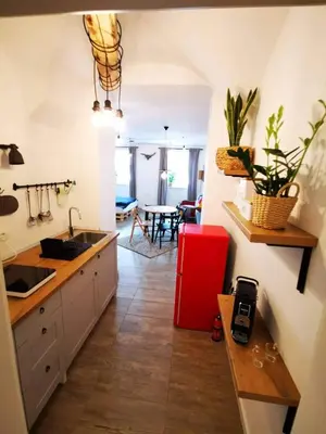 a kitchen with a sink and a red refrigerator at Sweetheart Apartment in Ljubljana