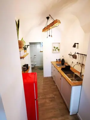 a kitchen with a sink and a red refrigerator at Sweetheart Apartment in Ljubljana