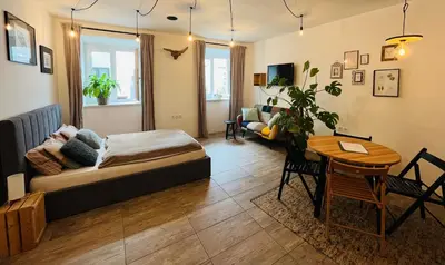 a living room with a bed and a table at Sweetheart Apartment in Ljubljana