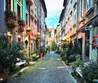 a cobblestone street in a city with buildings at Sweetheart Apartment in Ljubljana