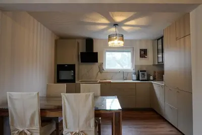 a kitchen with a table and chairs and a window at Emmas apartment with private parking and balcony in Ljubljana