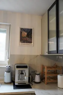 a kitchen with a coffee machine on a counter at Emmas apartment with private parking and balcony in Ljubljana