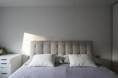 a bedroom with a large bed with two pillows at Emmas apartment with private parking and balcony in Ljubljana