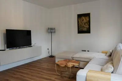 a living room with a couch and a flat screen tv at Emmas apartment with private parking and balcony in Ljubljana
