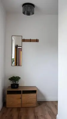 a room with a mirror and a wooden dresser at Emmas apartment with private parking and balcony in Ljubljana