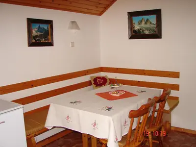 a dining room with a table with a white table cloth at Apartma Žvan in Bled