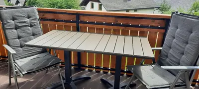 a table and two chairs sitting on a balcony at Apartma Žvan in Bled