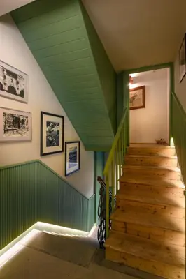 a green staircase in a house with a green ceiling at Franz Apartments in Ilirska Bistrica