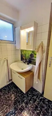 a bathroom with a sink and a mirror at Pr Pogorev in Begunje na Gorenjskem