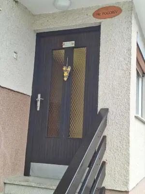 a wooden door with a butterfly on it at Pr Pogorev in Begunje na Gorenjskem