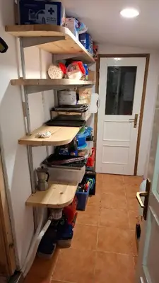 a room with wooden shelves and a door at Cabin on Kobilica Off Grid Alpine Eco Retreat with Stunning Views Trail access only hike&bike in Tržič