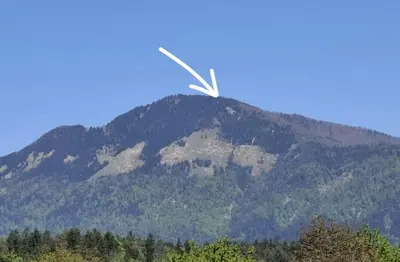 a bird flying in front of a mountain at Cabin on Kobilica Off Grid Alpine Eco Retreat with Stunning Views Trail access only hike&bike in Tržič