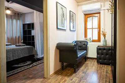 a bedroom with a bed and a chair and a mirror at Apartment Angel's Nest with Sauna and Fitness in Jesenice