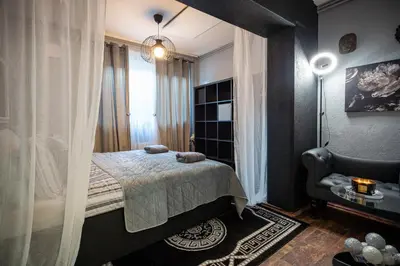 a bedroom with a bed and a window and a chair at Apartment Angel's Nest with Sauna and Fitness in Jesenice