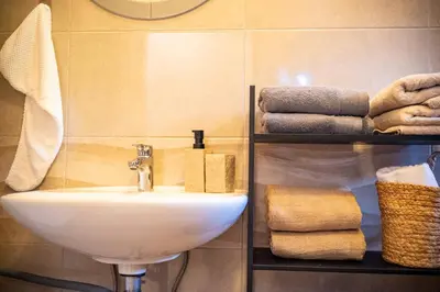 a bathroom with a sink and some towels at Apartment Angel's Nest with Sauna and Fitness in Jesenice
