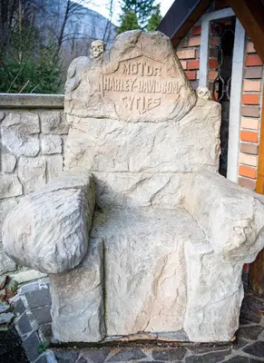 a statue of a lion sitting in front of a building at Apartment Angel's Nest with Sauna and Fitness in Jesenice