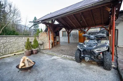 an atv parked in a garage with a house at Apartment Angel's Nest with Sauna and Fitness in Jesenice