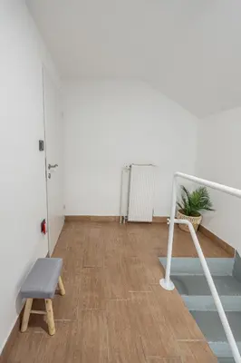 an empty room with a chair and a door at 2 Bedroom Apartment Sima with Seasonal Shared Pool in Ivančna Gorica