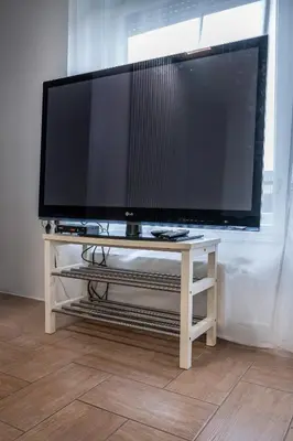 a large flat screen tv sitting on a white table at 2 Bedroom Apartment Sima with Seasonal Shared Pool in Ivančna Gorica
